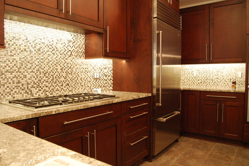 Cherry Cabinets with Under the Cabinet Lighting and Mosaic Backsplash and Tahoe Granite Countertop